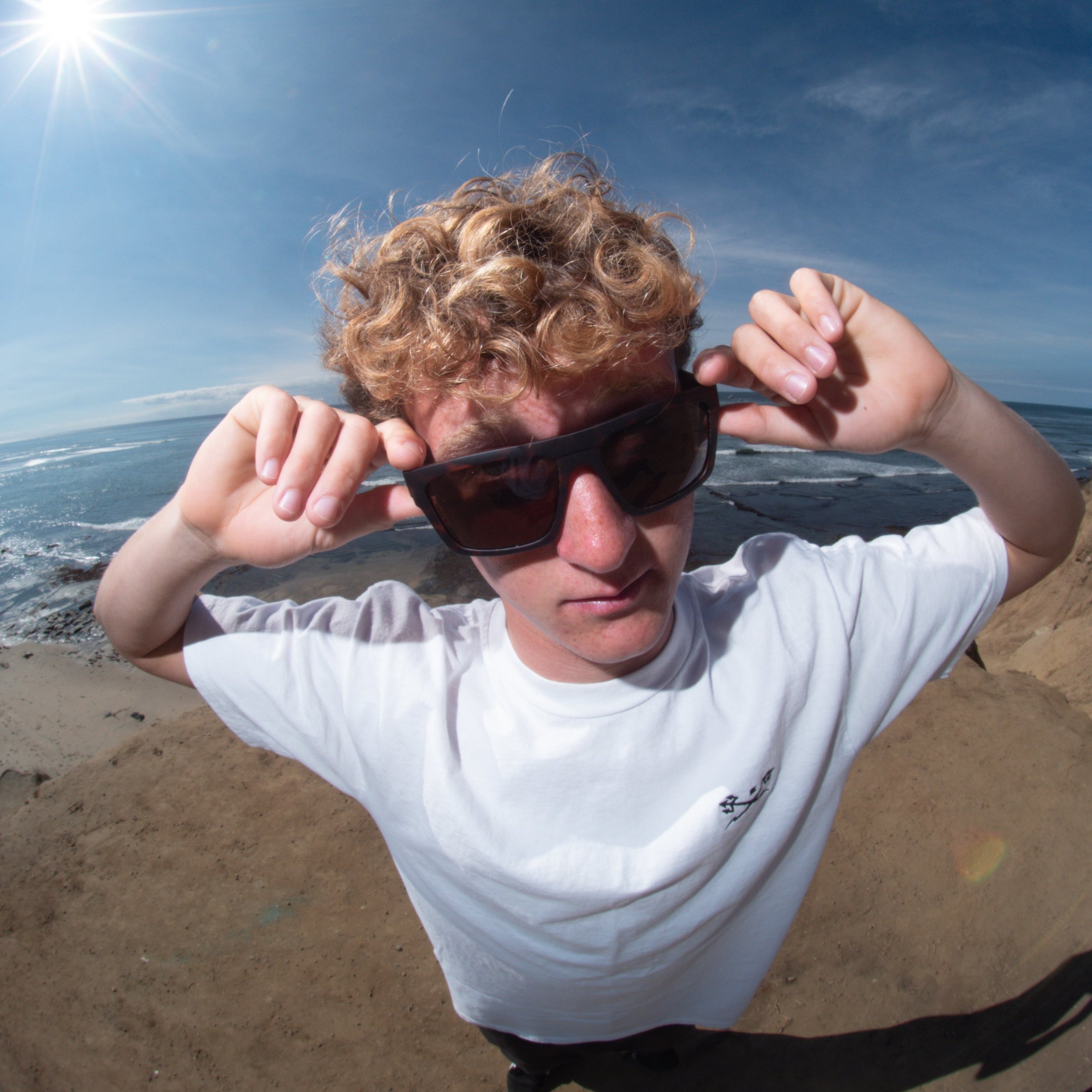 Person on a beach with sunglasses