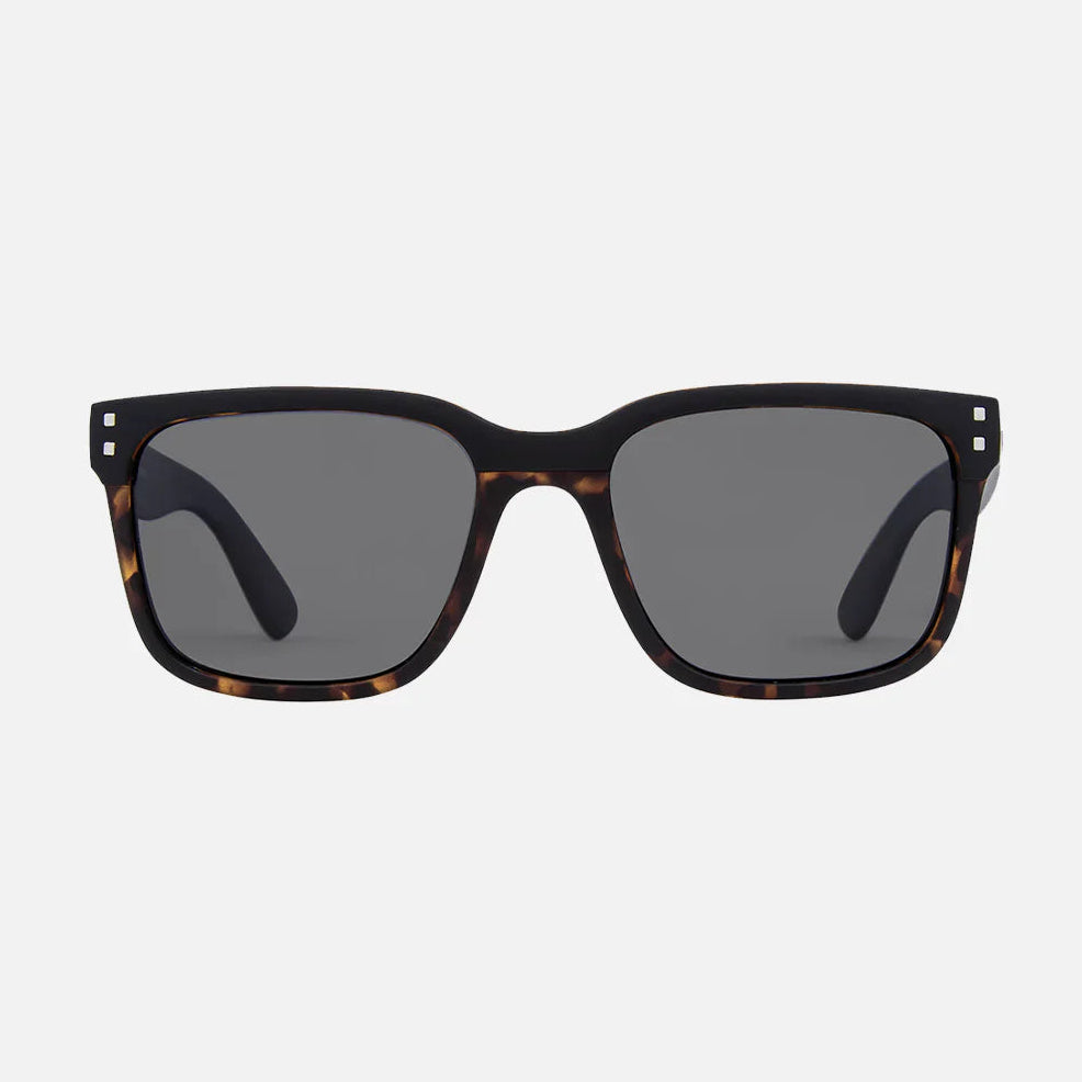 Sunglasses with tortoiseshell frame and dark lenses on a white background