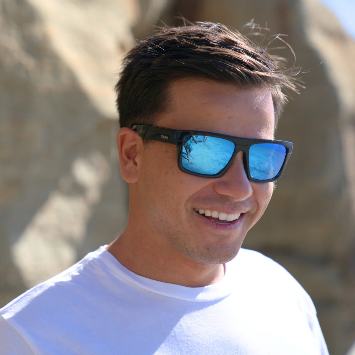 Man wearing sunglasses with a blurred natural background